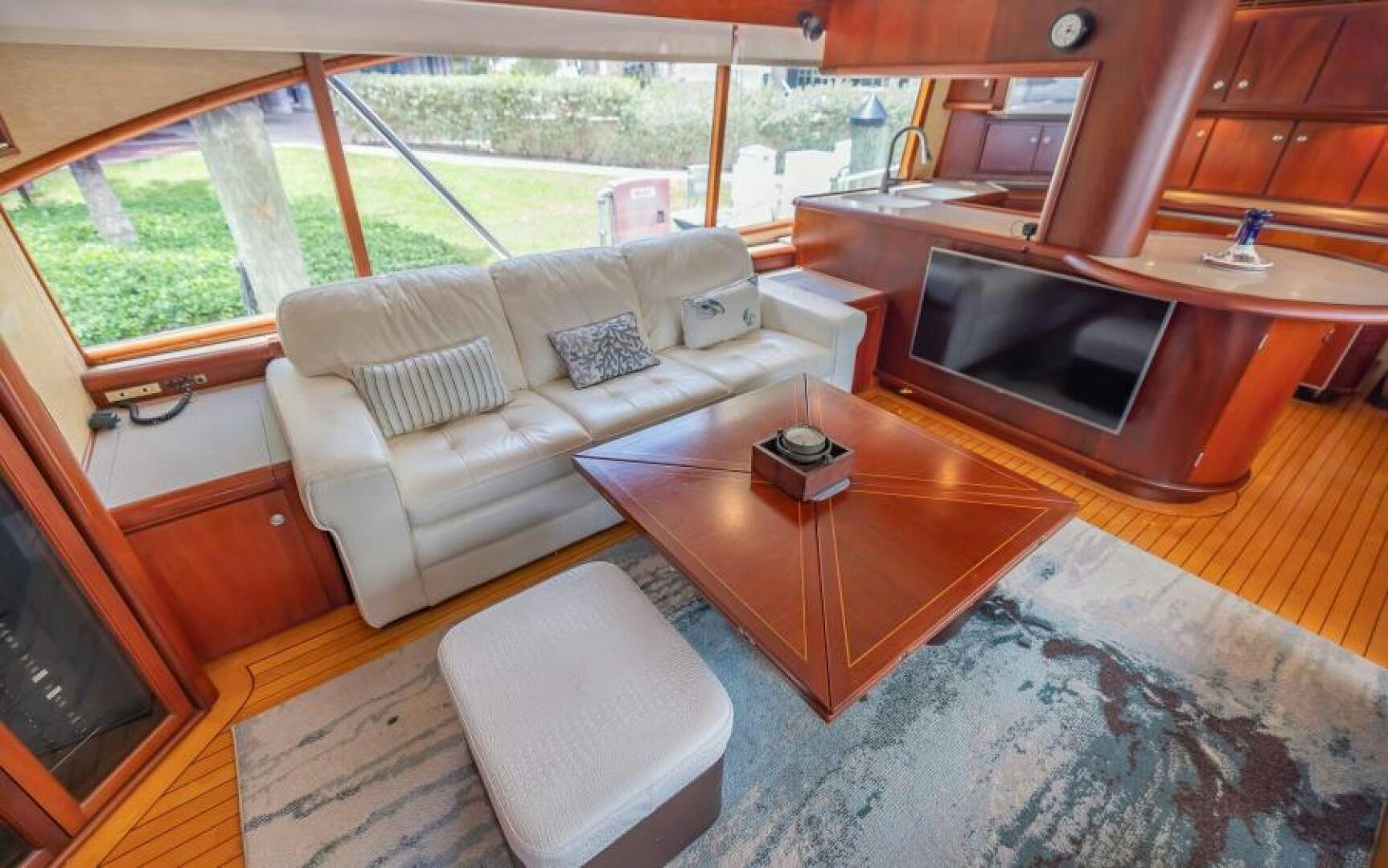 a living room with a couch and a television aboard BOOMER Yacht for Sale