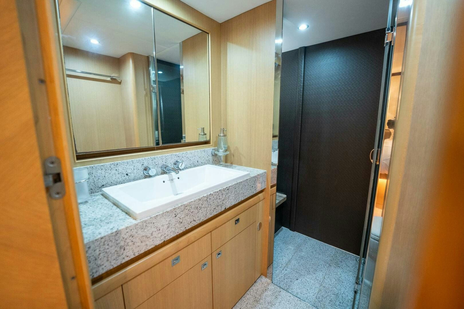 a bathroom with a large mirror aboard NO CURFEW Yacht for Sale