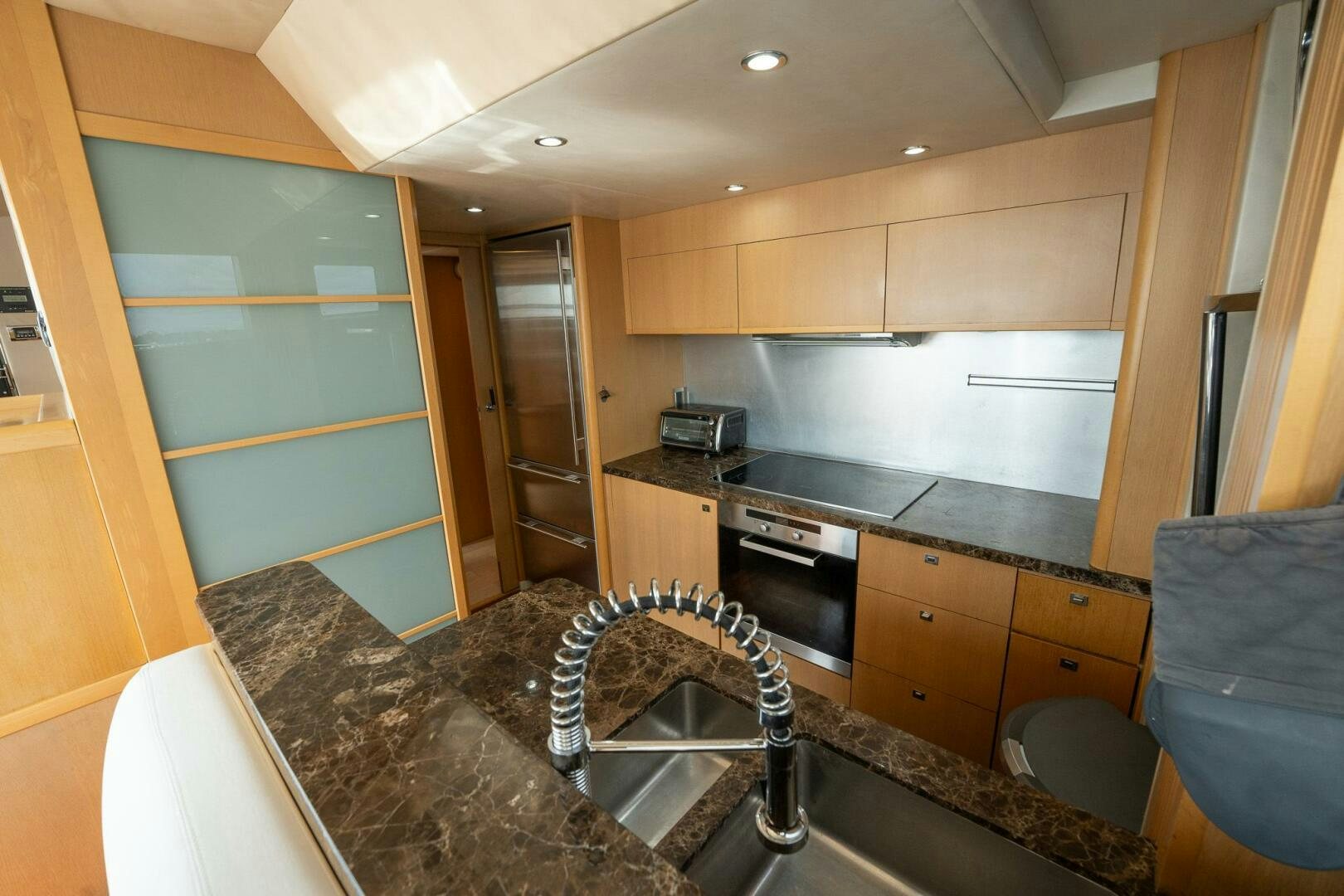 a kitchen with a marble counter top aboard NO CURFEW Yacht for Sale
