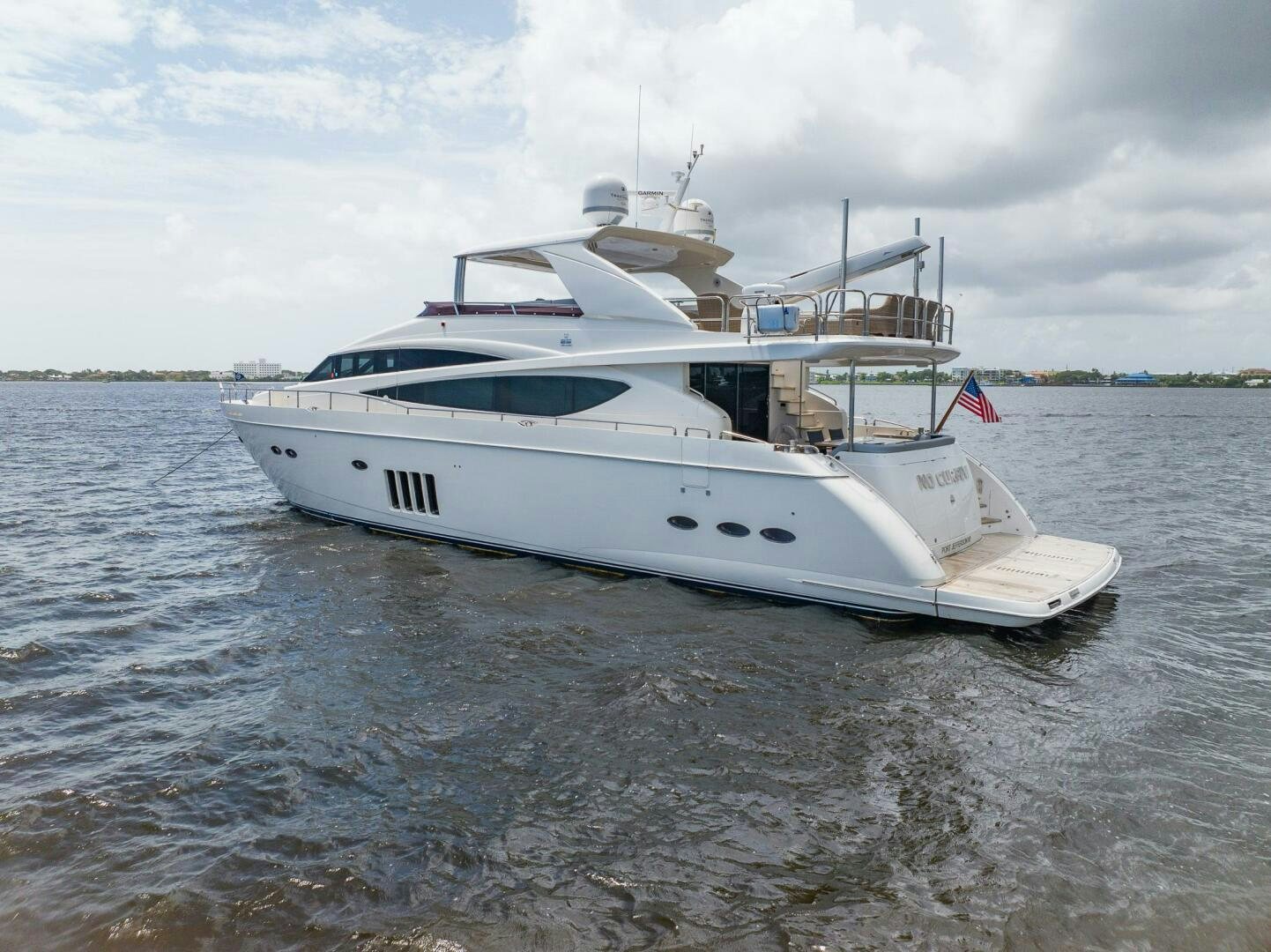 a white boat on the water aboard NO CURFEW Yacht for Sale