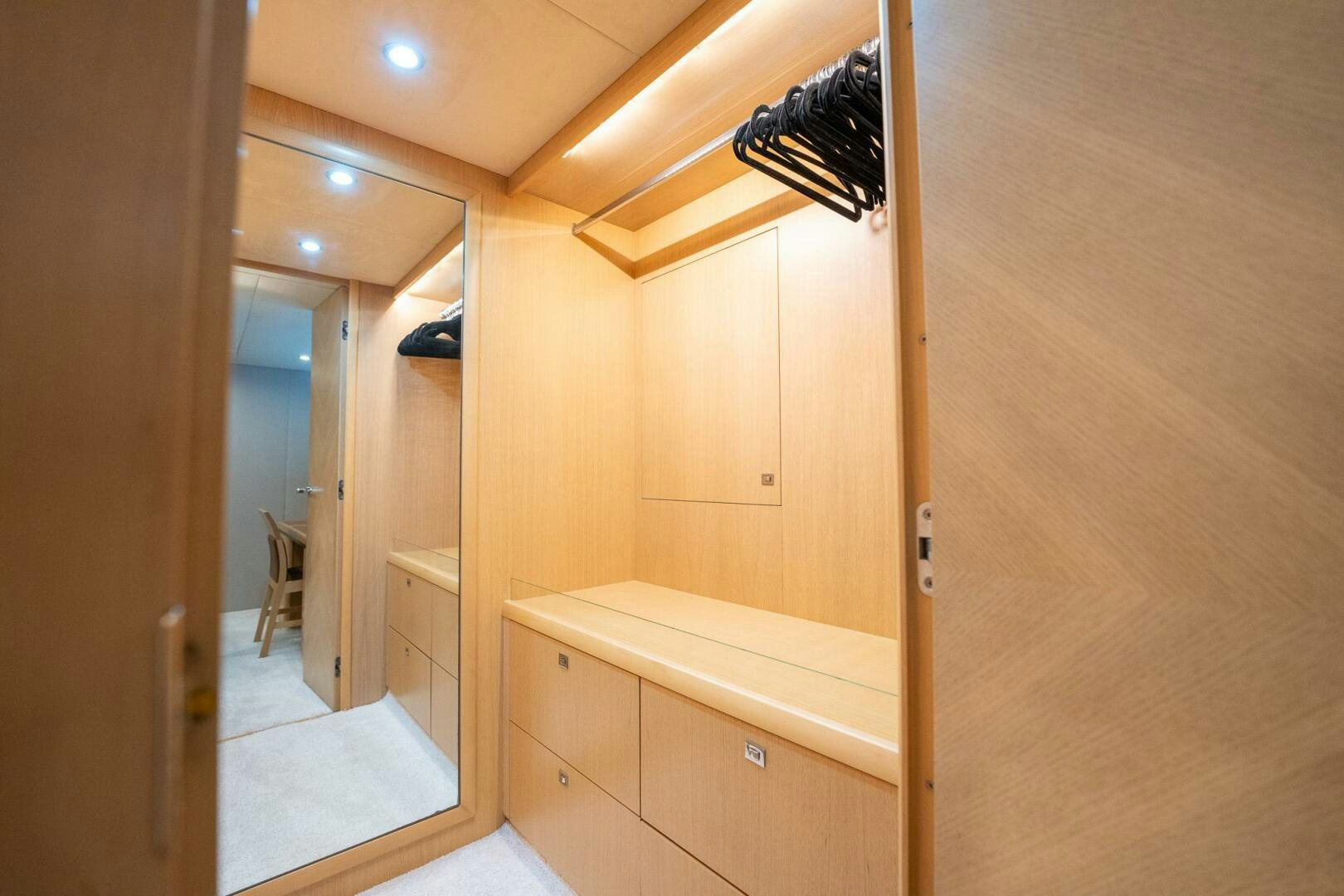 a room with a wood floor and a mirror aboard NO CURFEW Yacht for Sale