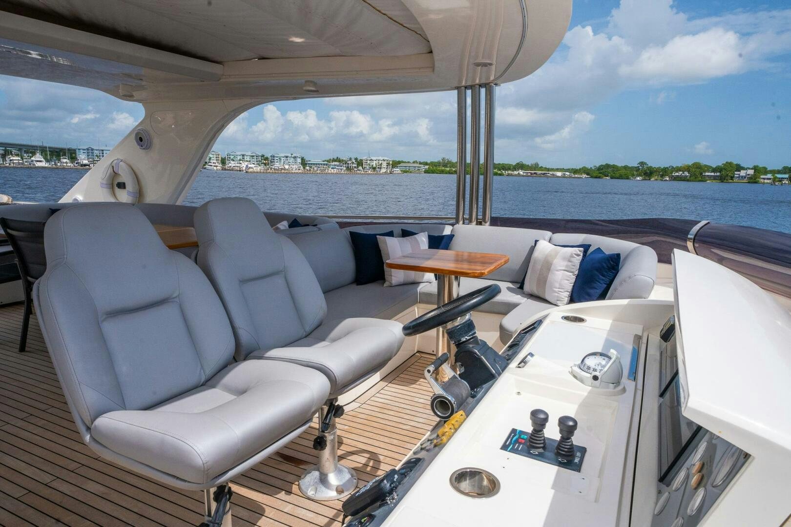 a boat with a table and chairs aboard NO CURFEW Yacht for Sale