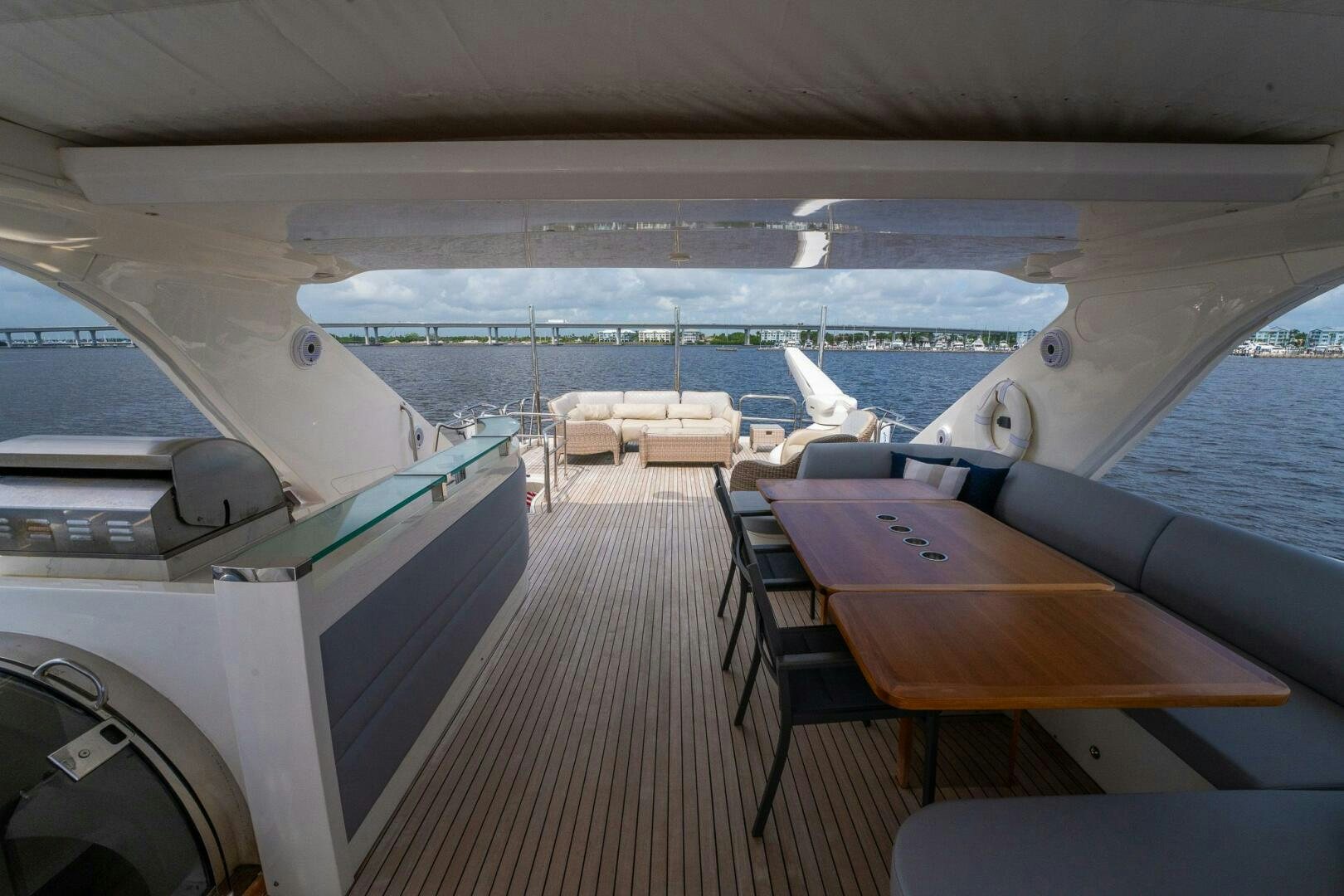 a deck with a view of the water and boats on it aboard NO CURFEW Yacht for Sale