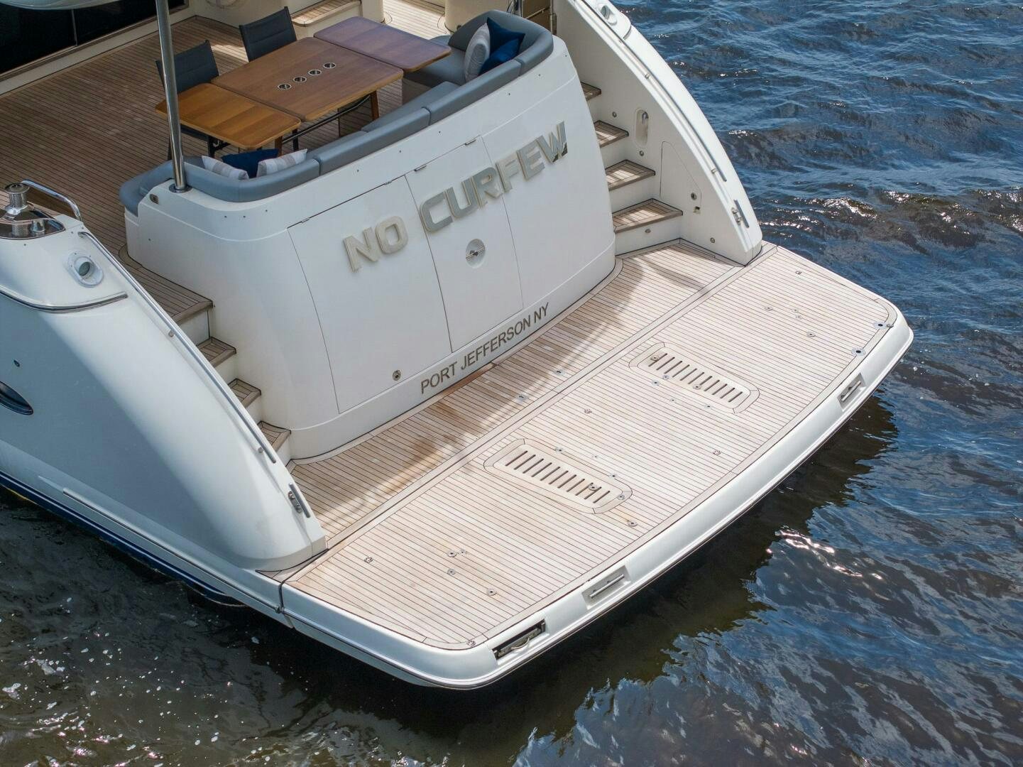 a white boat on the water aboard NO CURFEW Yacht for Sale