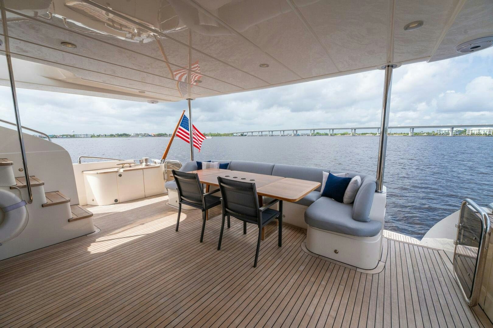 a table and chairs on a deck aboard NO CURFEW Yacht for Sale