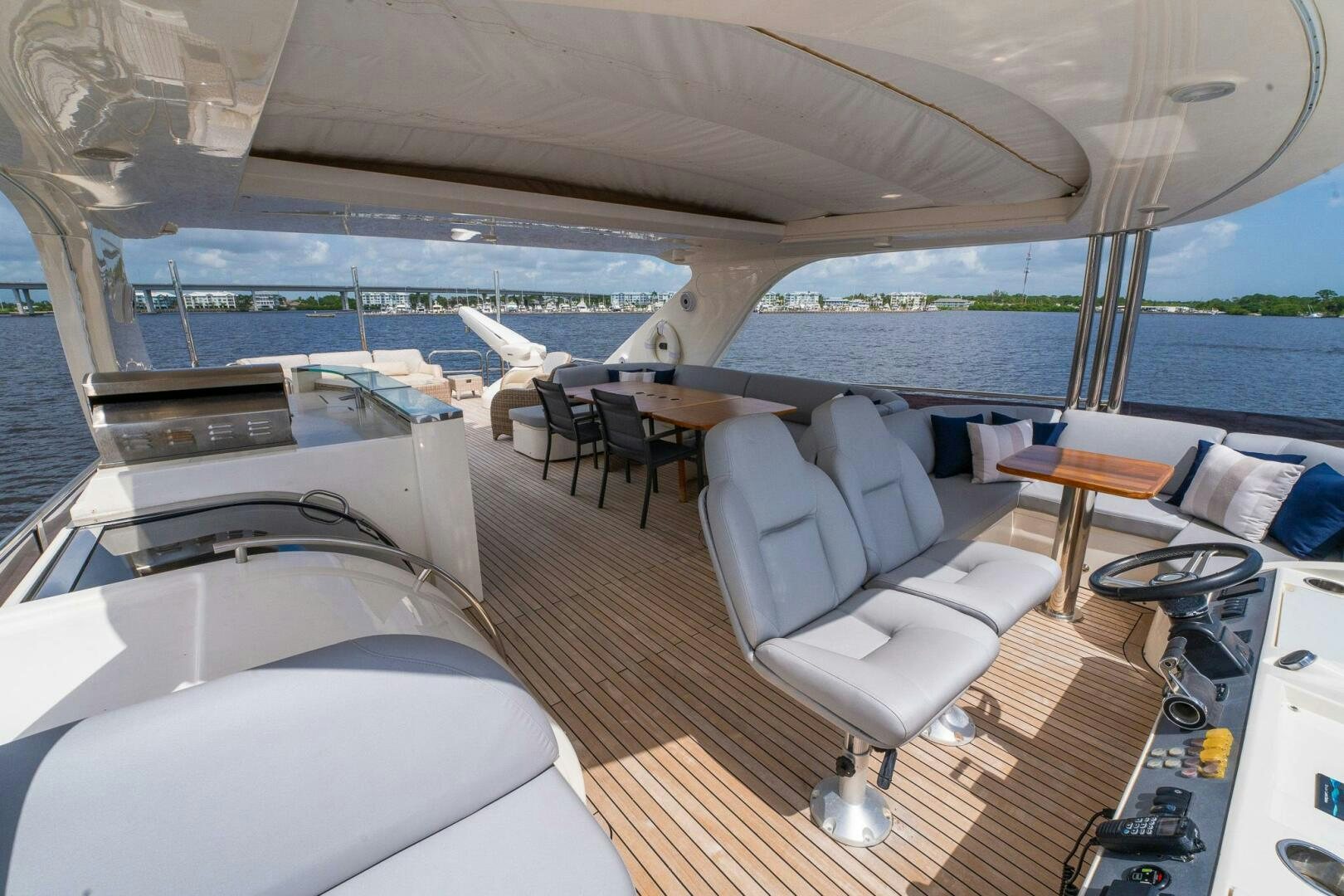 a boat with a deck and chairs aboard NO CURFEW Yacht for Sale