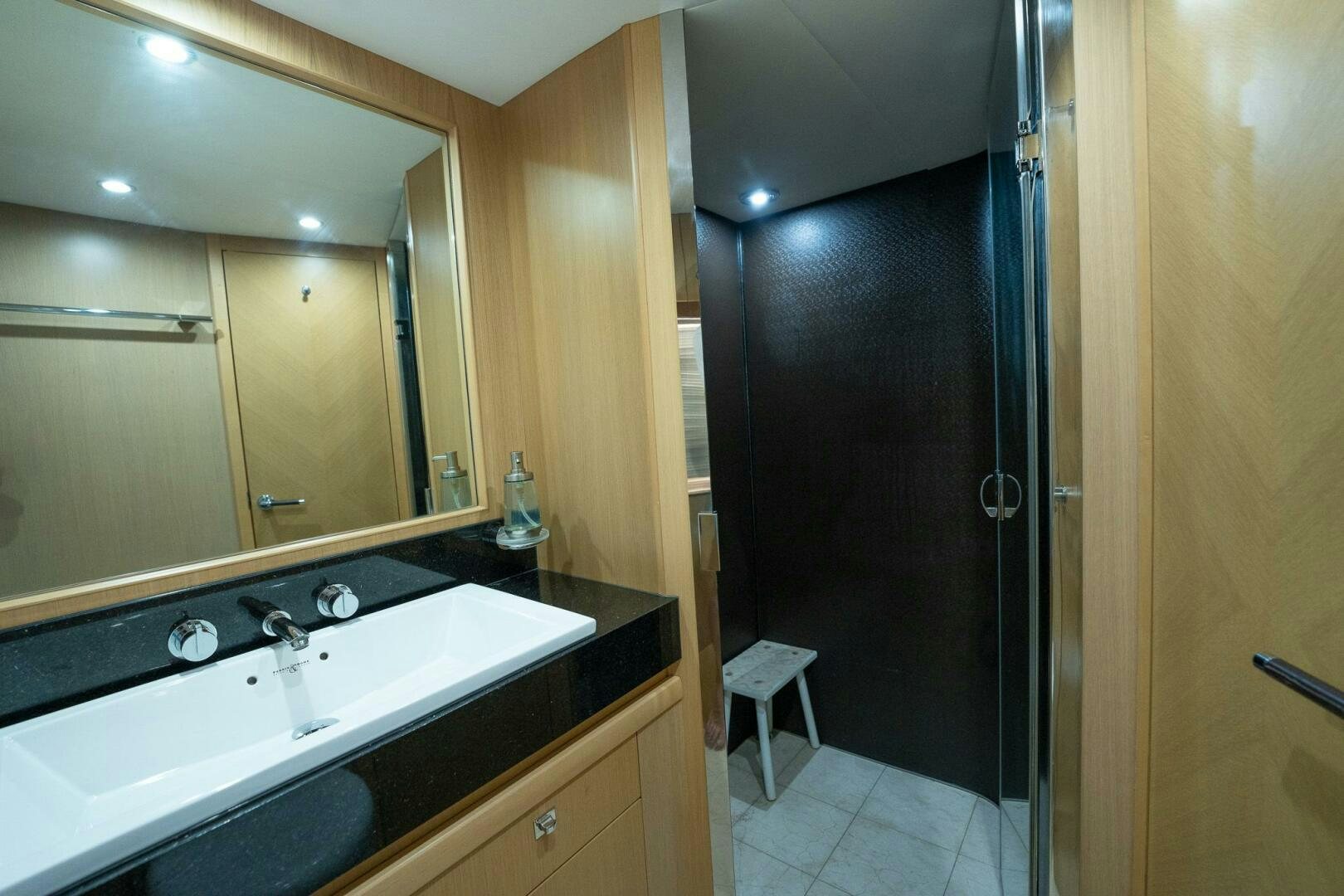 a bathroom with a sink and a mirror aboard NO CURFEW Yacht for Sale