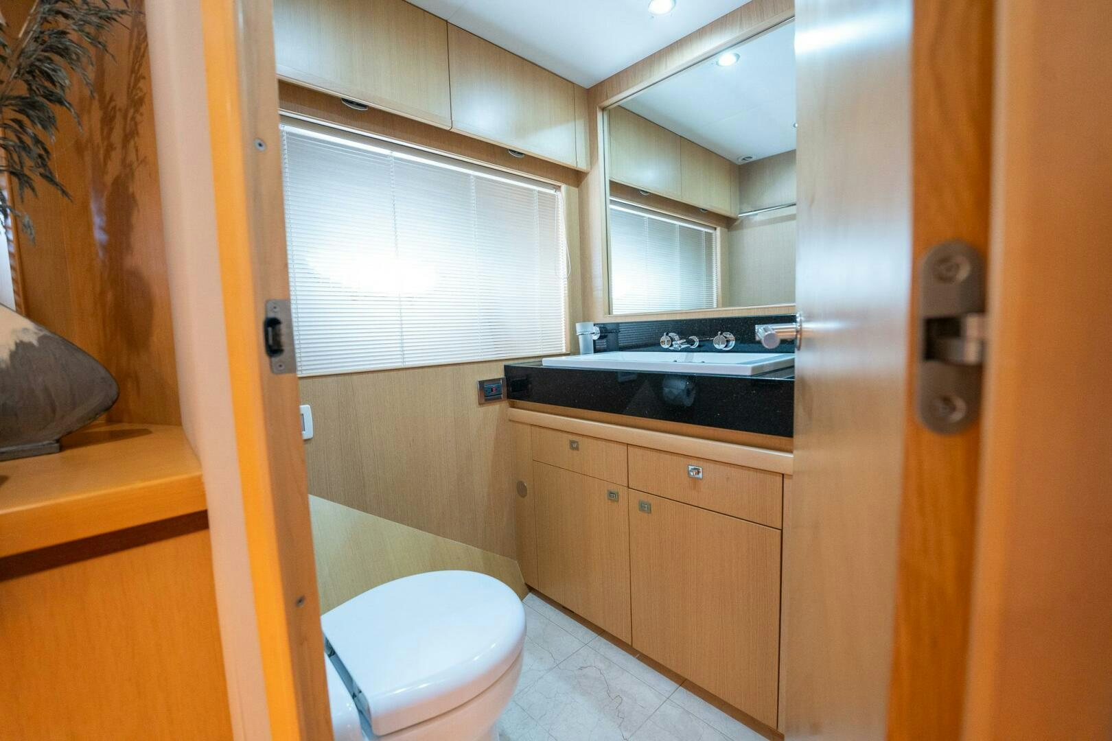 a bathroom with a sink and a toilet aboard NO CURFEW Yacht for Sale