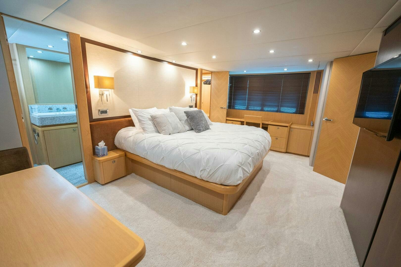 a bedroom with a bed and a desk aboard NO CURFEW Yacht for Sale