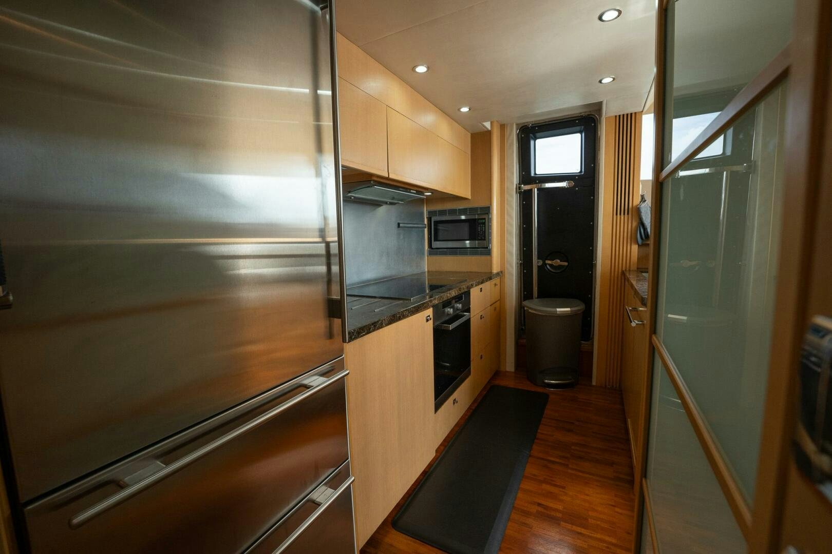 a kitchen with stainless steel appliances aboard NO CURFEW Yacht for Sale