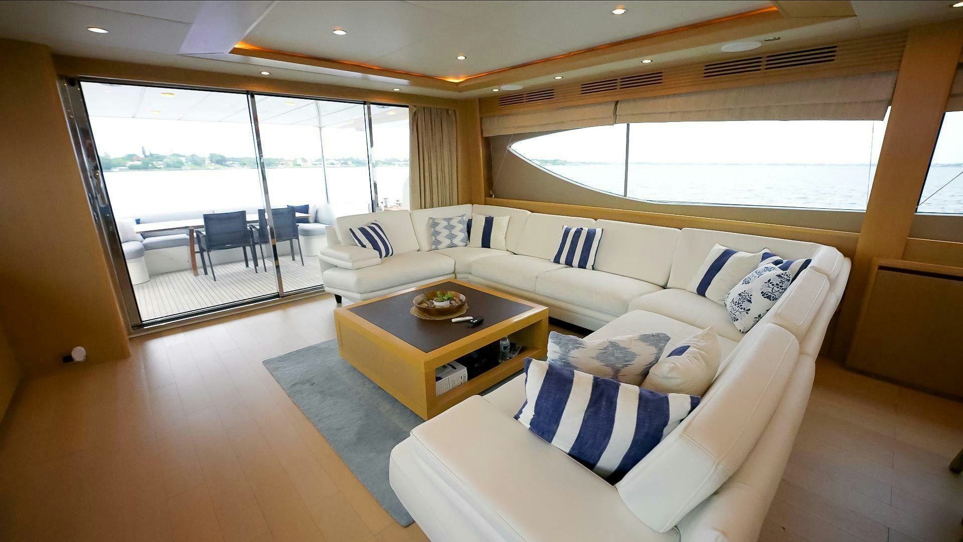 a living room with a couch and a coffee table aboard NO CURFEW Yacht for Sale