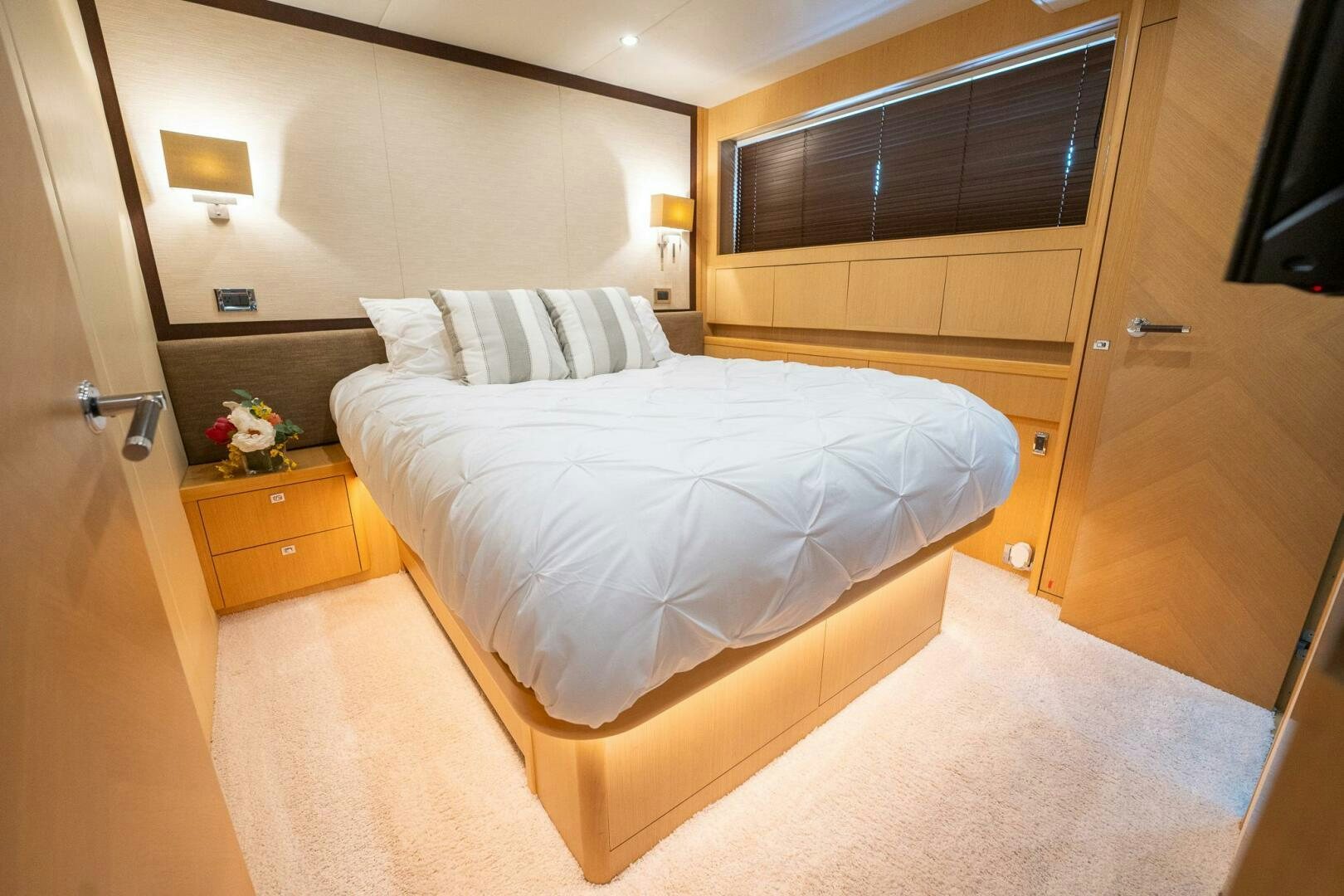 a bedroom with a bed and a desk aboard NO CURFEW Yacht for Sale