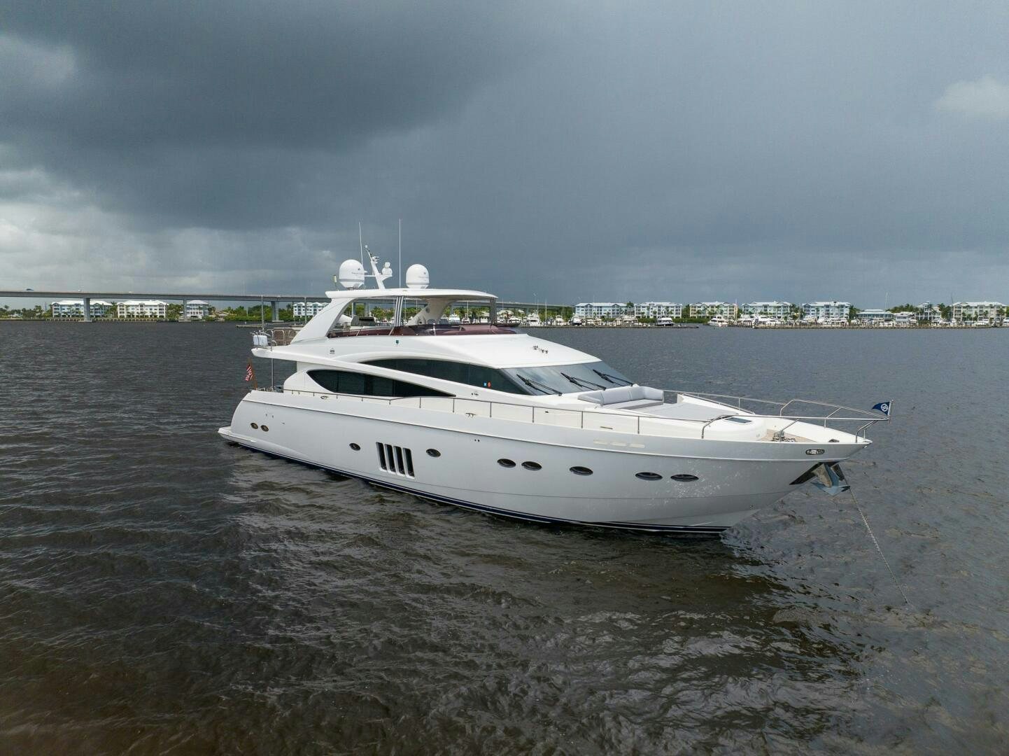 a white yacht on the water aboard NO CURFEW Yacht for Sale