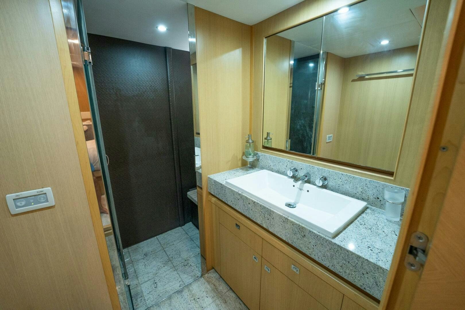 a bathroom with a sink and a mirror aboard NO CURFEW Yacht for Sale