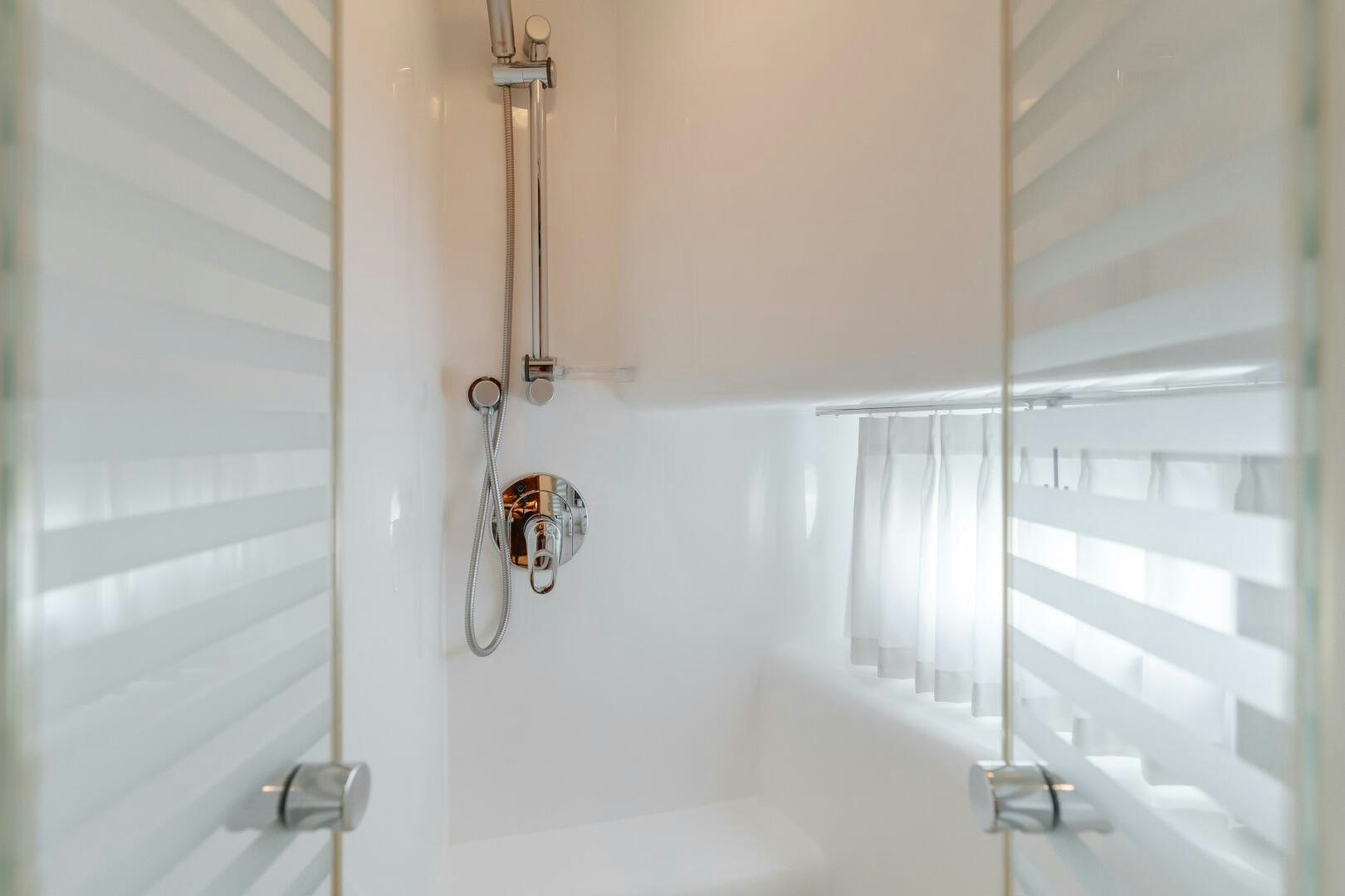 a white bathroom with a shower aboard LADY LAURA Yacht for Sale