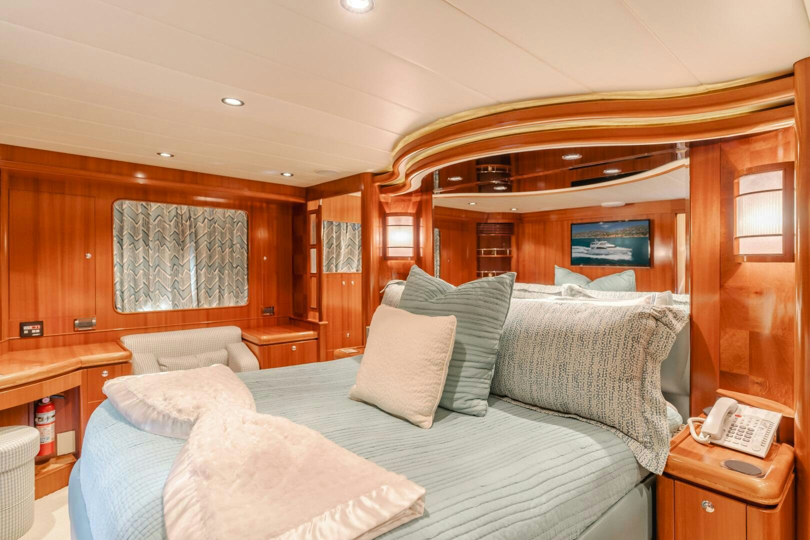 a bed with pillows and a chair aboard LADY LAURA Yacht for Sale