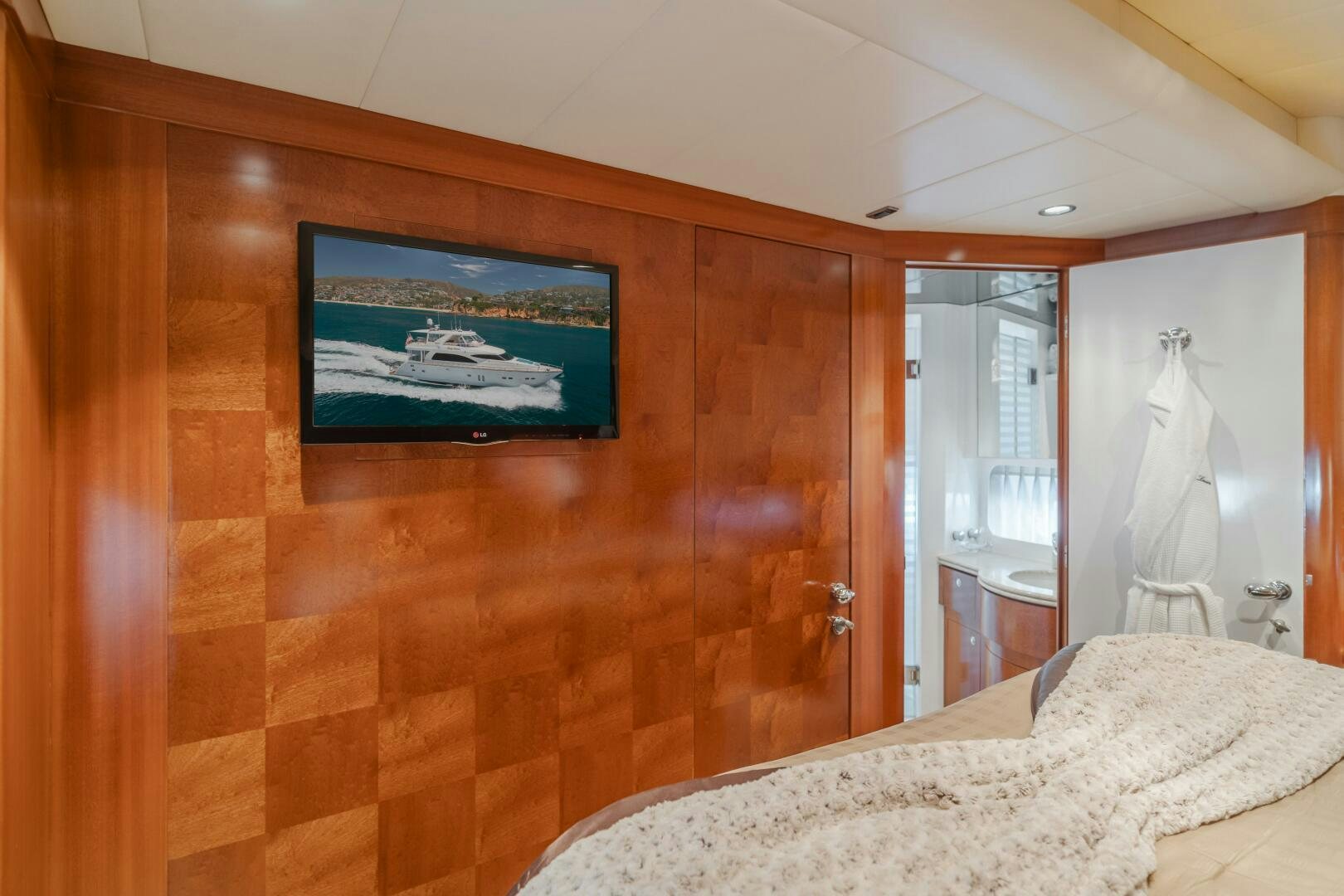 a room with a bed and a television on the wall aboard LADY LAURA Yacht for Sale