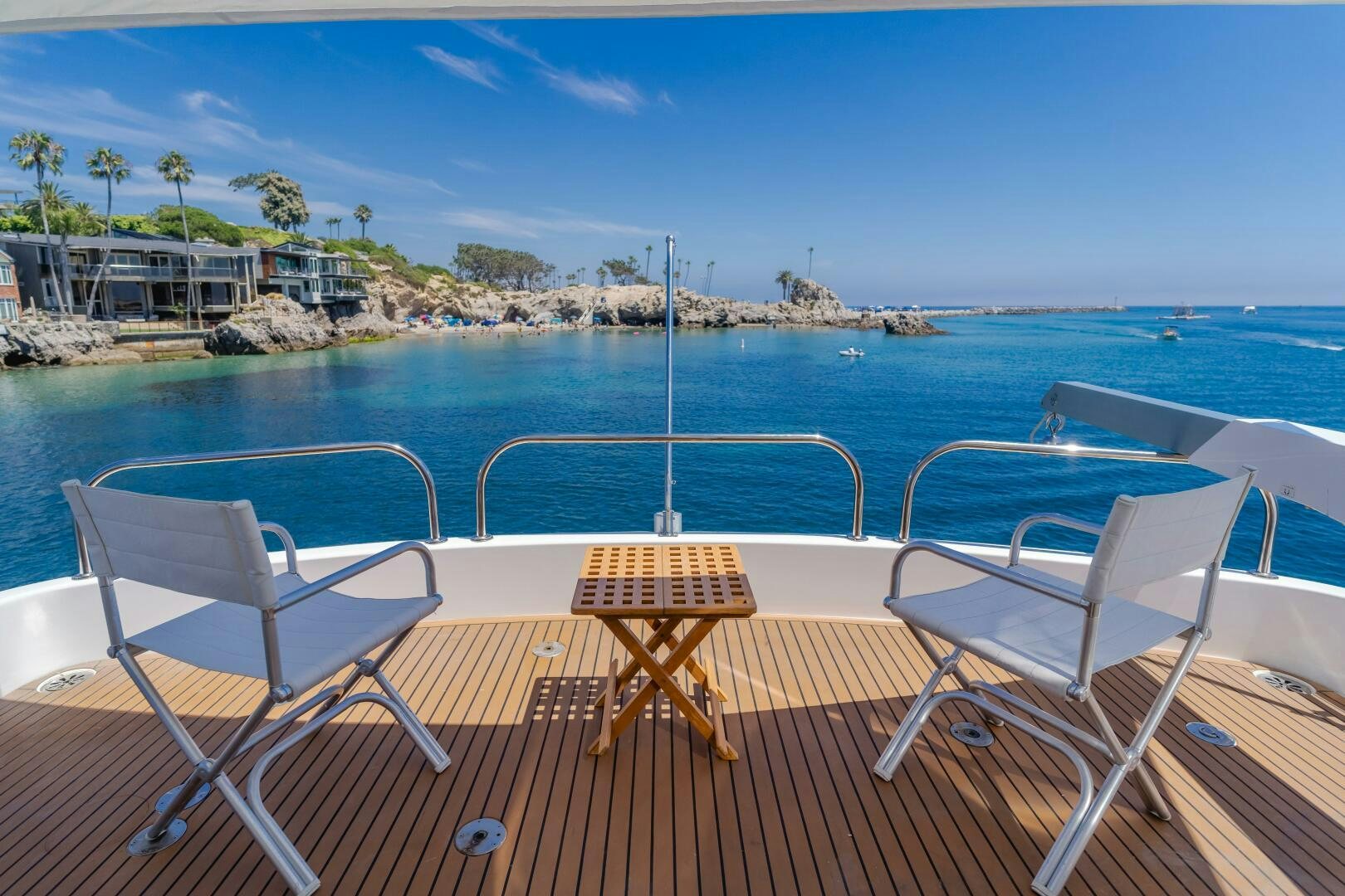 a deck with chairs and a body of water in the background aboard LADY LAURA Yacht for Sale