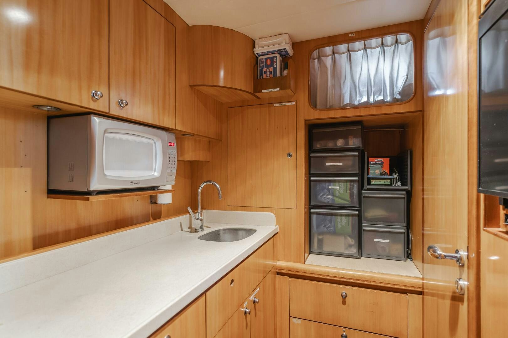 a kitchen with wooden cabinets aboard LADY LAURA Yacht for Sale