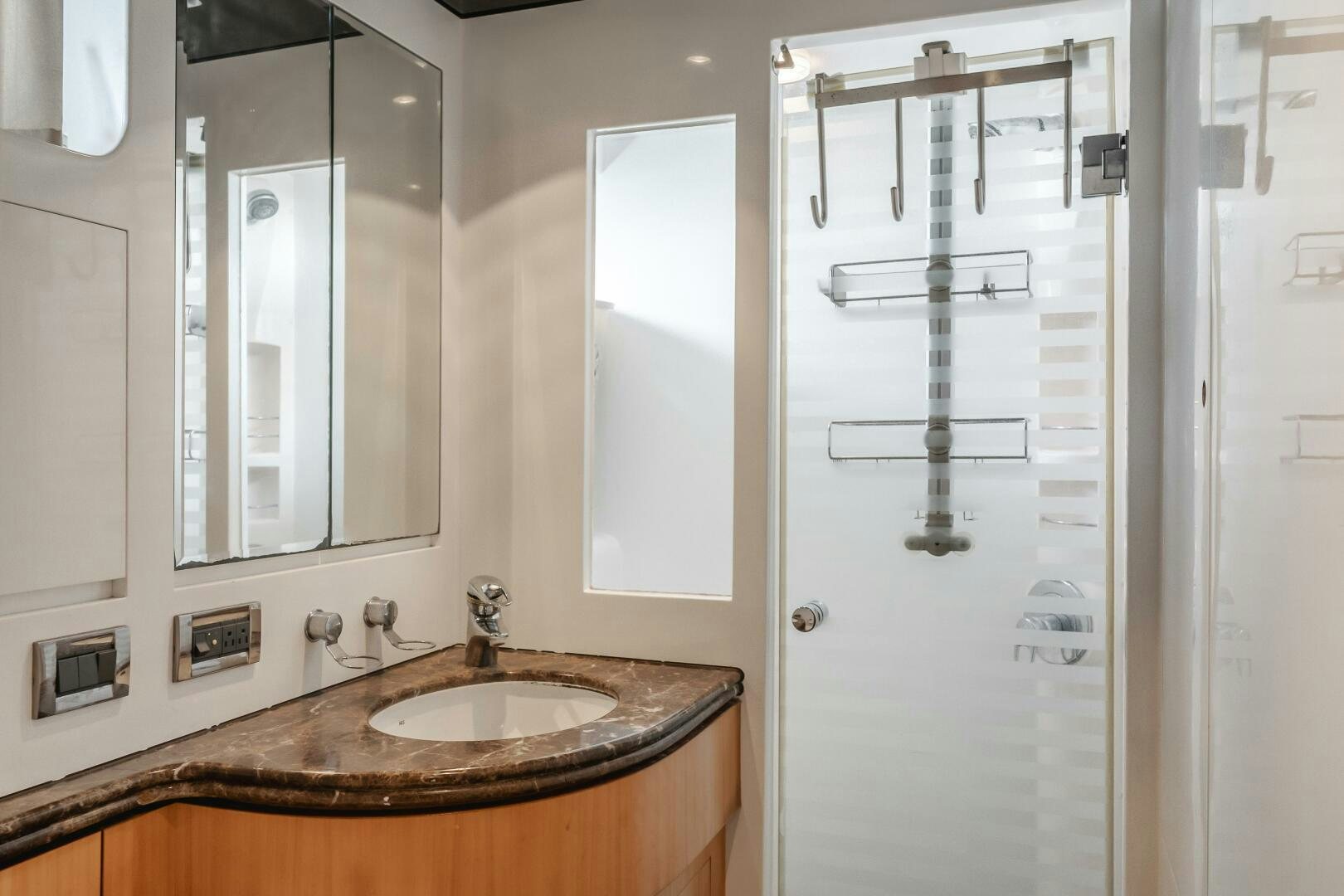 a bathroom with a sink and mirror aboard LADY LAURA Yacht for Sale