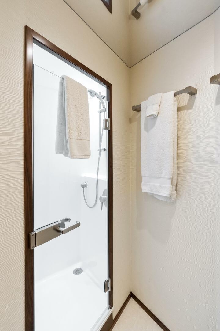 a bathroom with a door and a mirror aboard SOLONIAN Yacht for Sale