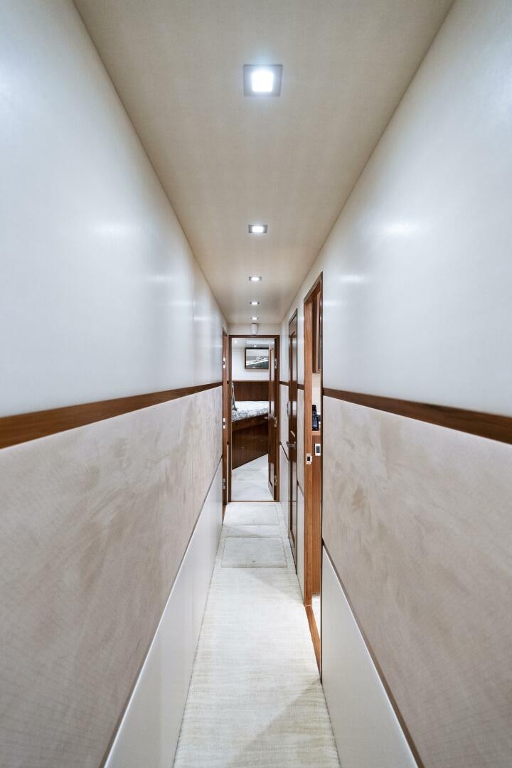 a long hallway with wooden doors aboard SOLONIAN Yacht for Sale