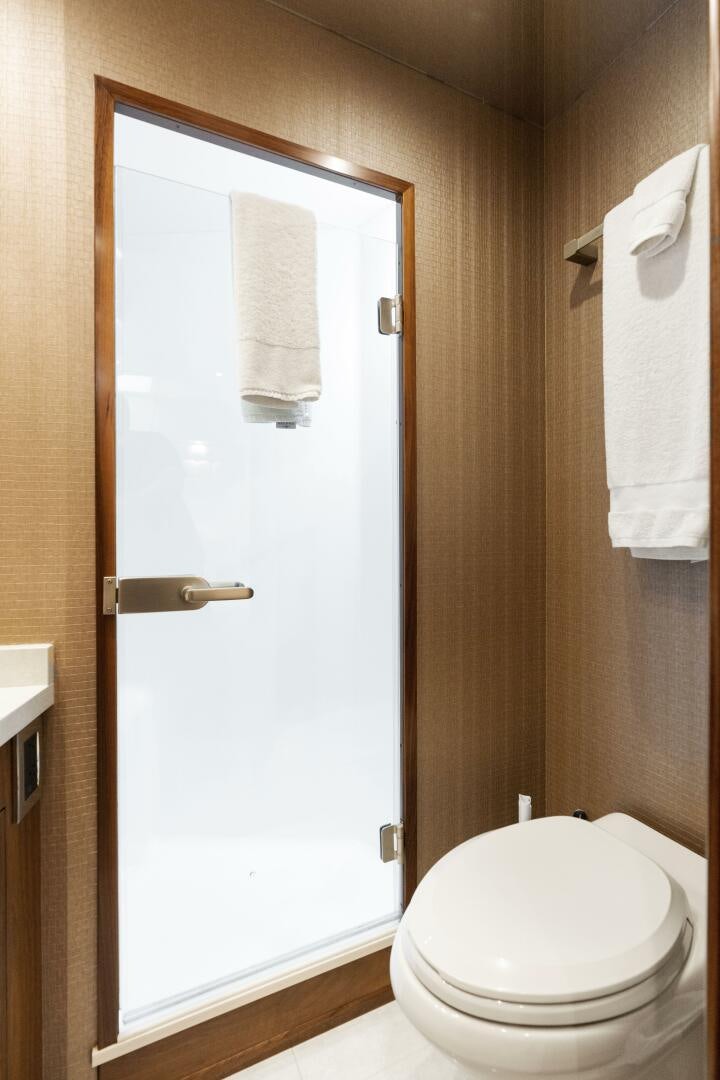 a bathroom with a toilet and a shower aboard SOLONIAN Yacht for Sale