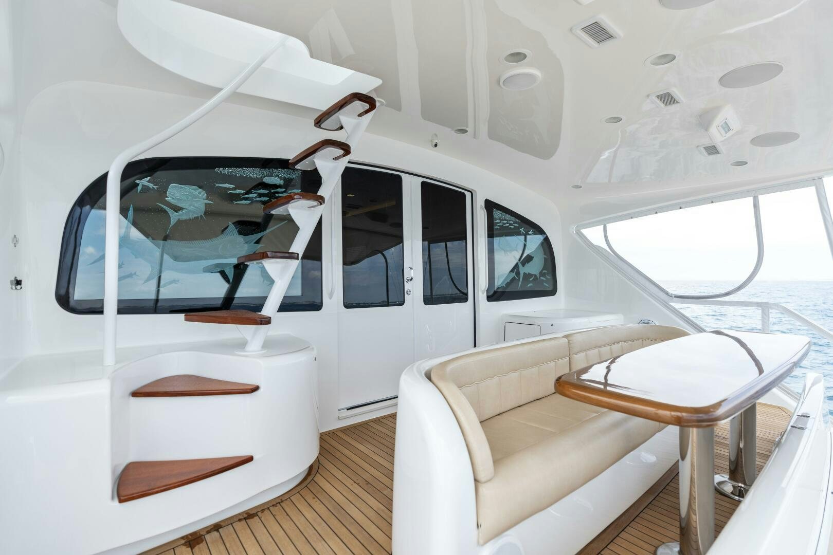 a white room with a white chair and a table and a white chair aboard SOLONIAN Yacht for Sale