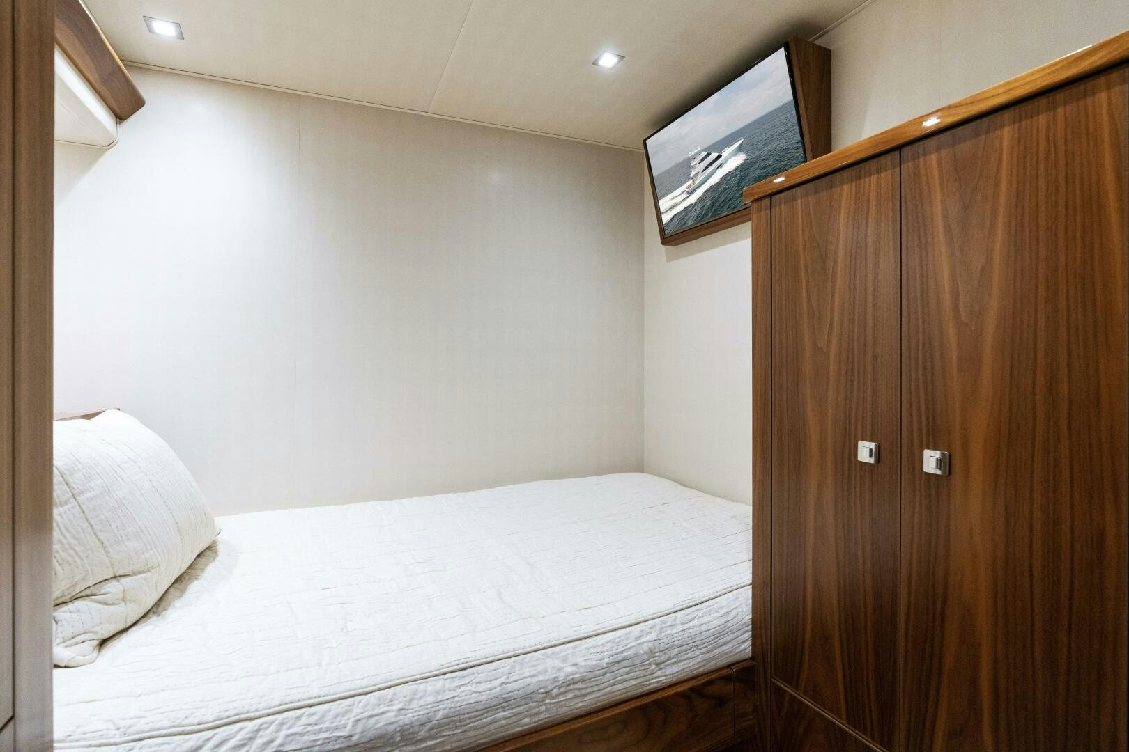 a bed with a wooden headboard aboard SOLONIAN Yacht for Sale