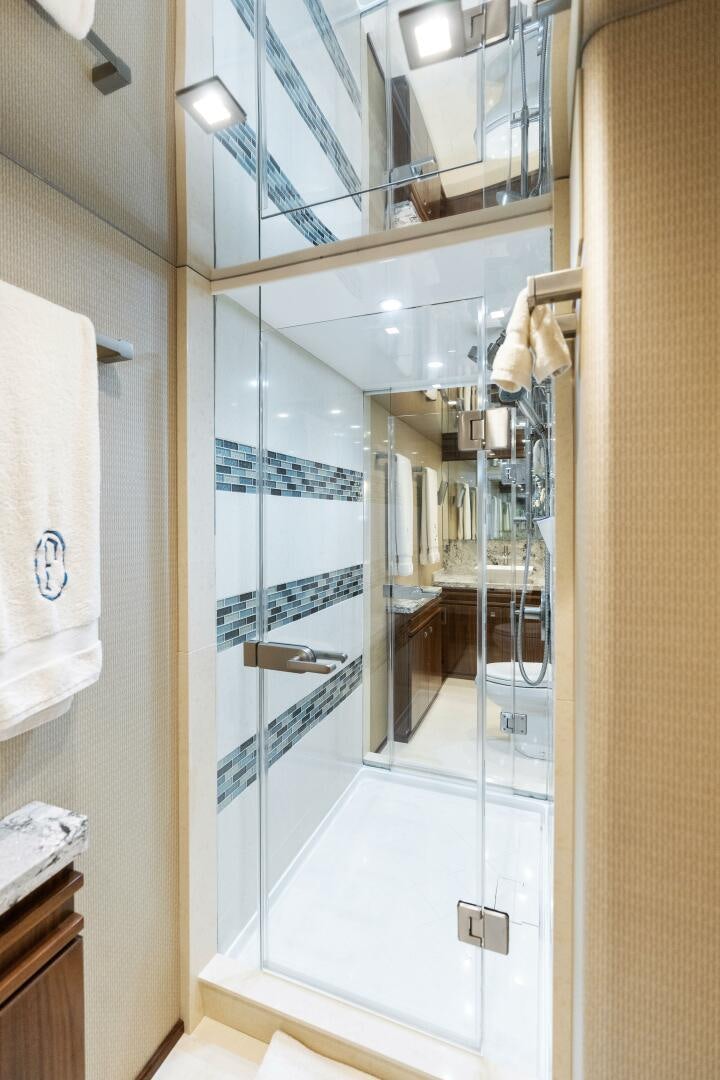 a bathroom with a glass shower aboard SOLONIAN Yacht for Sale