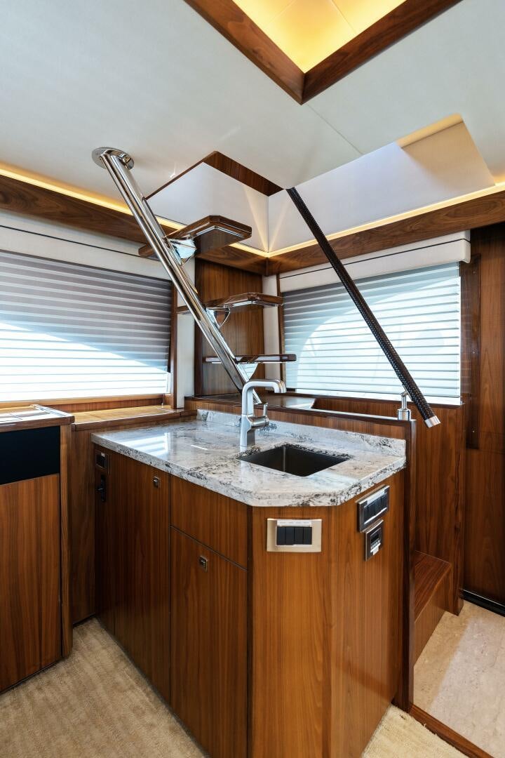 a kitchen with a sink and a ladder aboard SOLONIAN Yacht for Sale