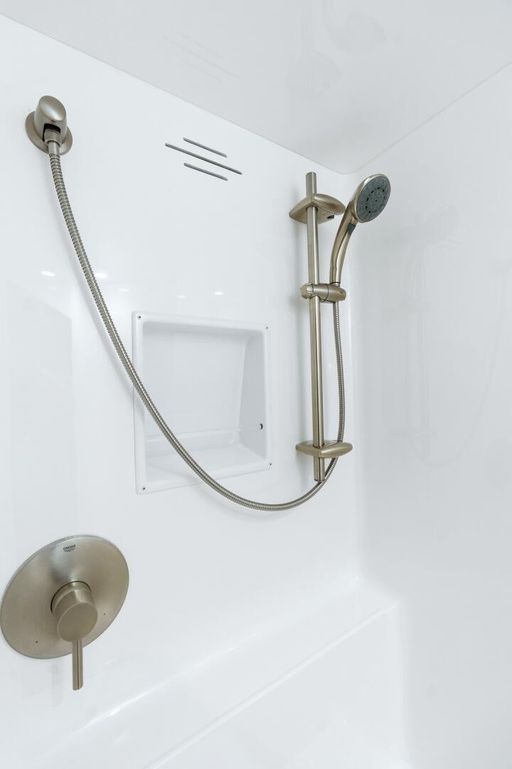 a white wall with a mirror and a light fixture aboard SOLONIAN Yacht for Sale