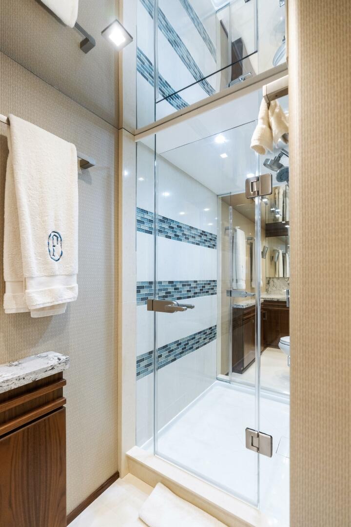 a bathroom with a glass shower aboard SOLONIAN Yacht for Sale