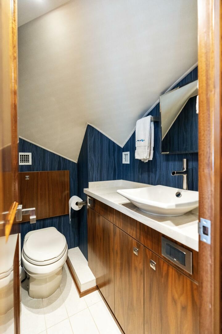 a bathroom with a toilet and sink aboard SOLONIAN Yacht for Sale