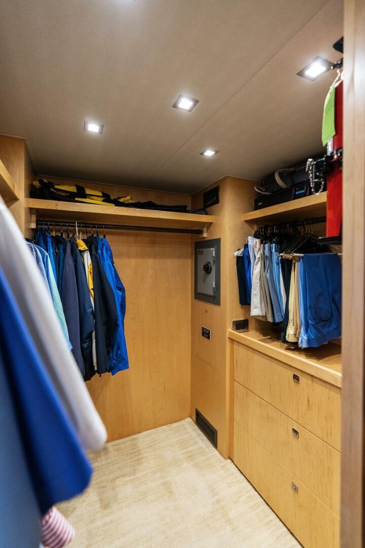 a closet with clothes on the wall aboard SOLONIAN Yacht for Sale
