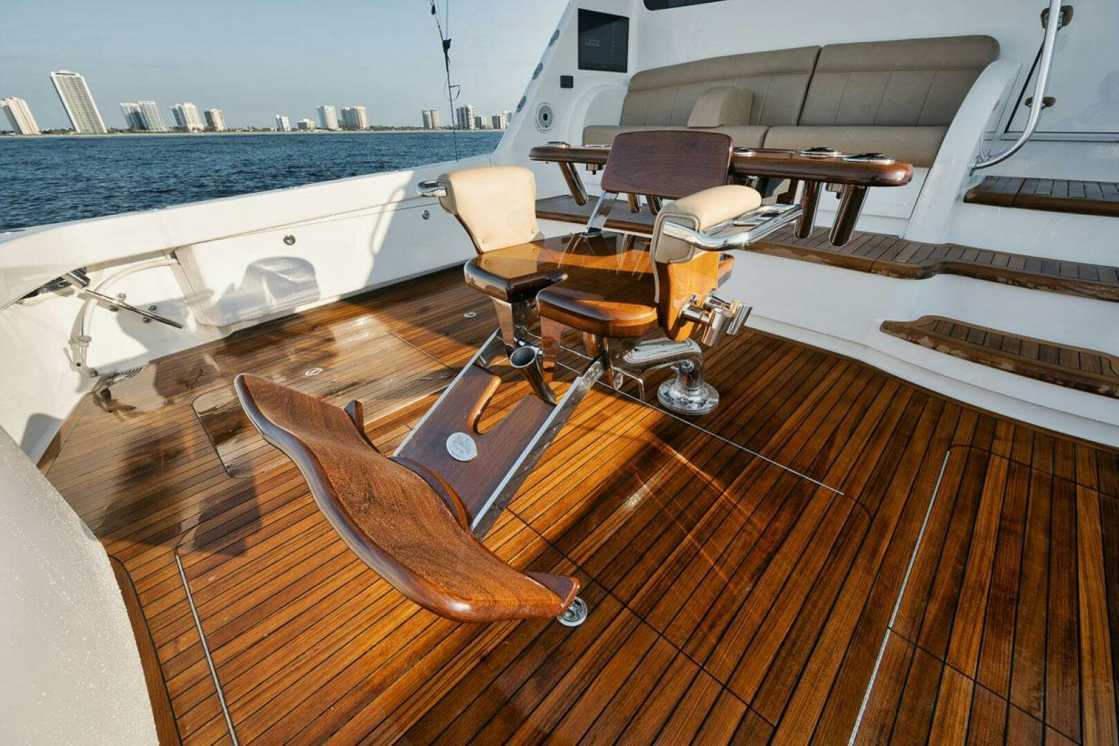 a wooden deck with chairs and a table on it aboard WHY KNOT Yacht for Sale