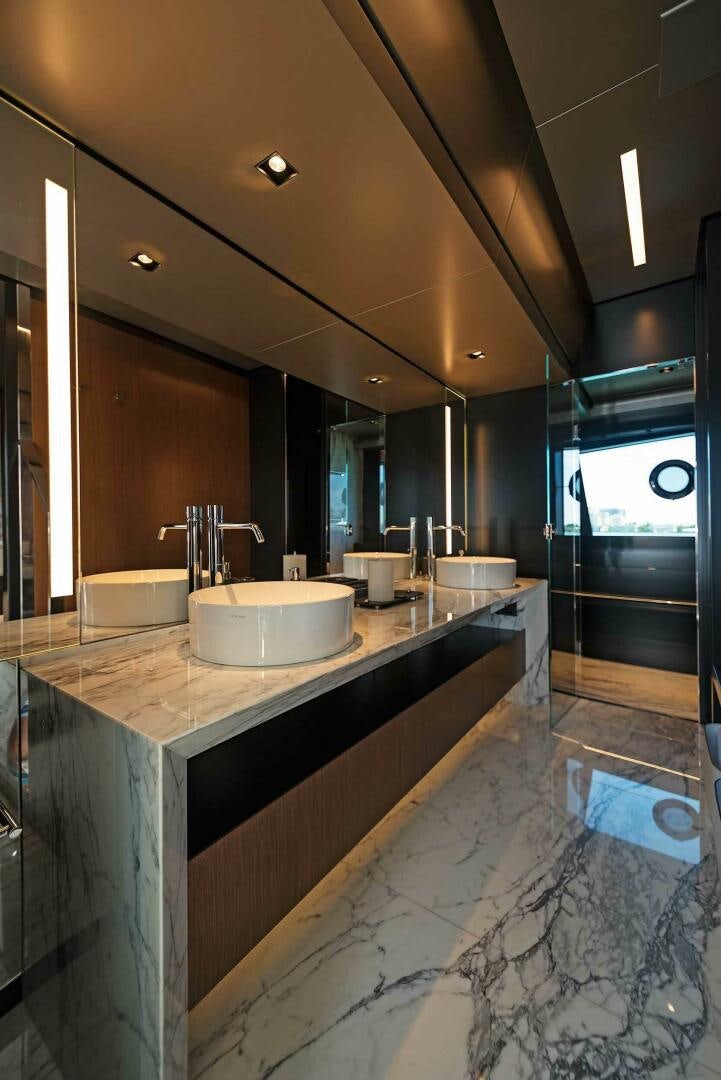 a bathroom with a countertop sink and a large mirror aboard ALEGRA Yacht for Sale
