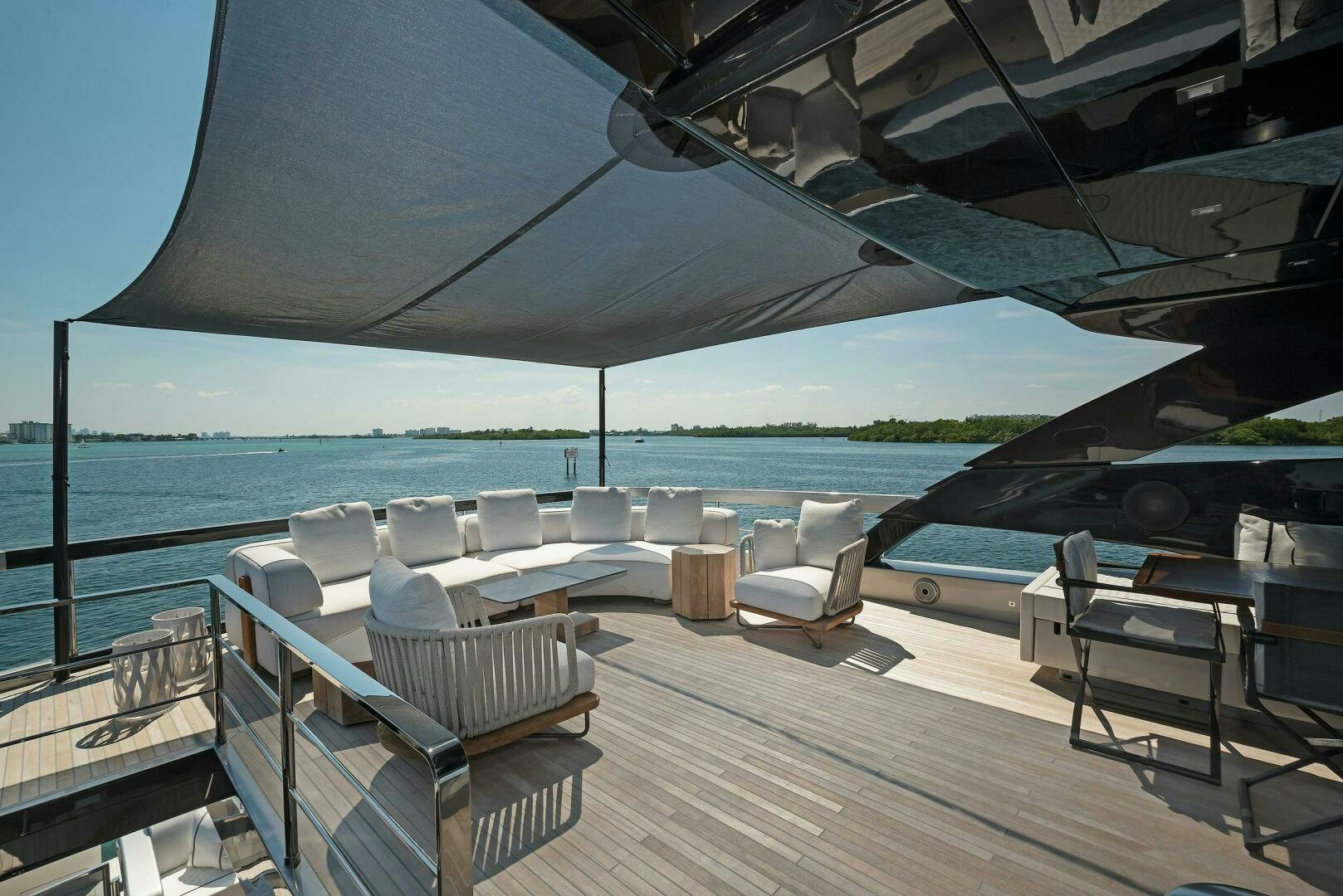 a deck with chairs and a large body of water in the background aboard ALEGRA Yacht for Sale