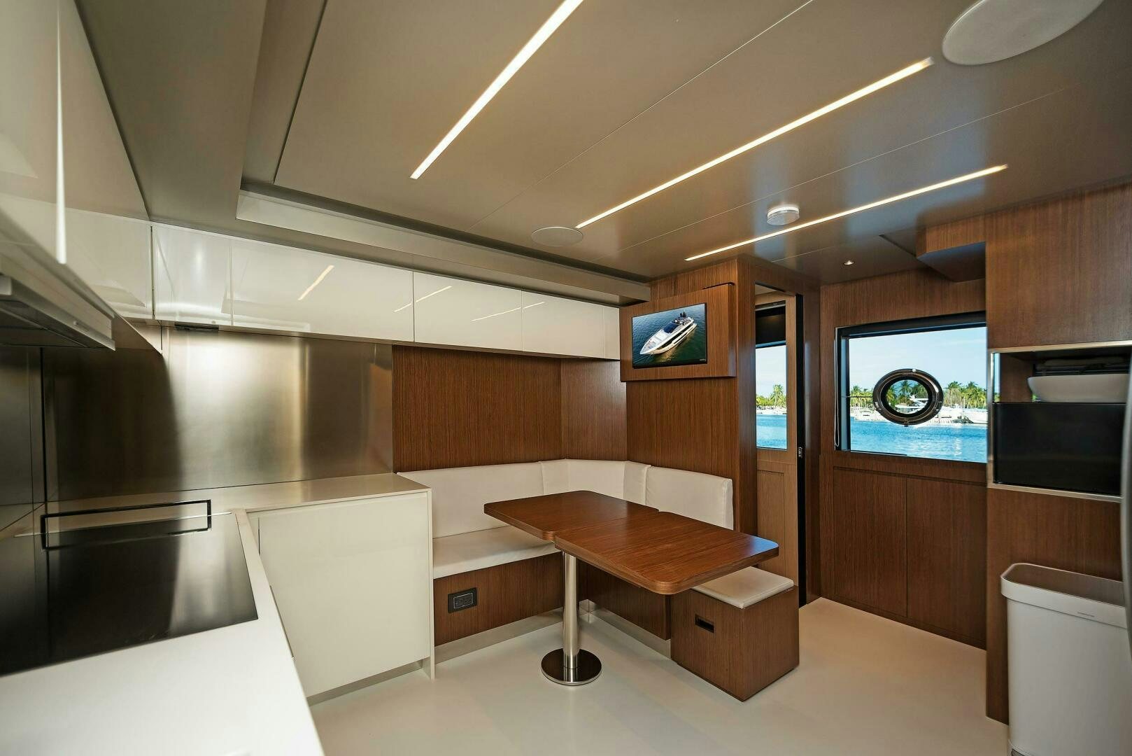 a kitchen with a table and tv aboard ALEGRA Yacht for Sale