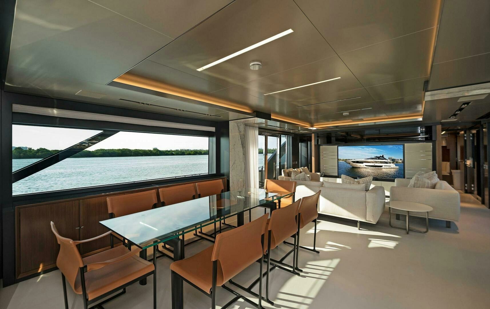 a room with a table chairs and a large window aboard ALEGRA Yacht for Sale