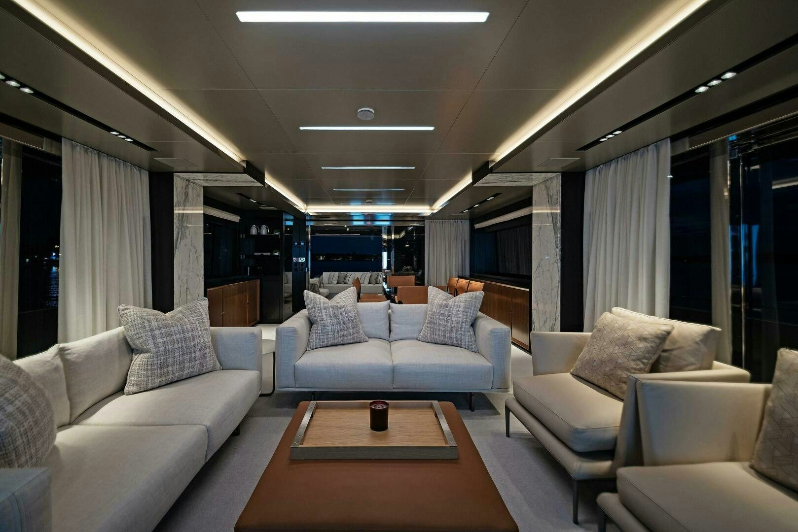a living room with a table and couches aboard ALEGRA Yacht for Sale