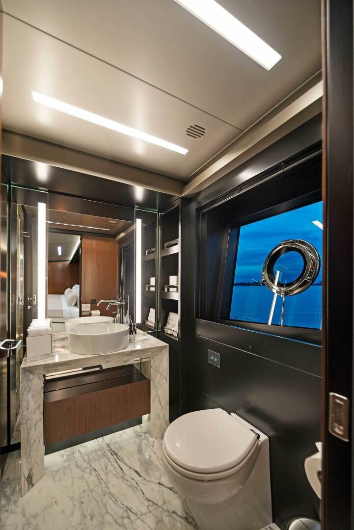 a bathroom with a sink toilet and a mirror aboard ALEGRA Yacht for Sale