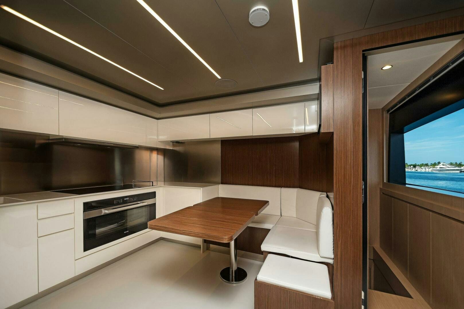 a kitchen with a table and chairs aboard ALEGRA Yacht for Sale