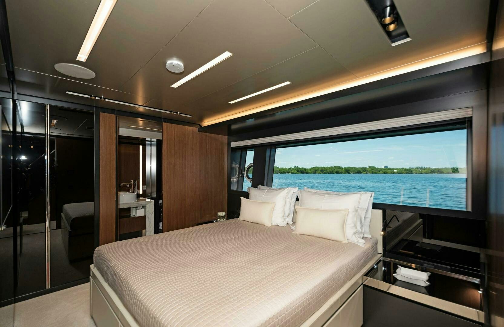 a room with a bed and a large window aboard ALEGRA Yacht for Sale