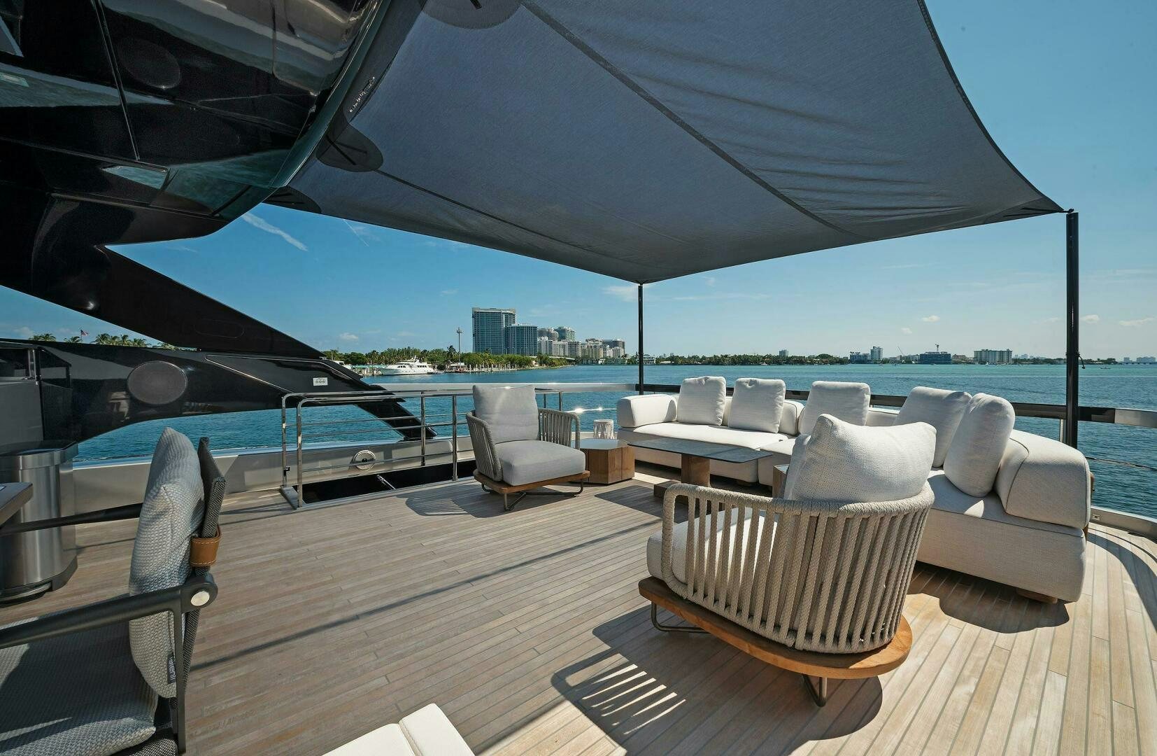a deck with a view of the ocean and a large city aboard ALEGRA Yacht for Sale