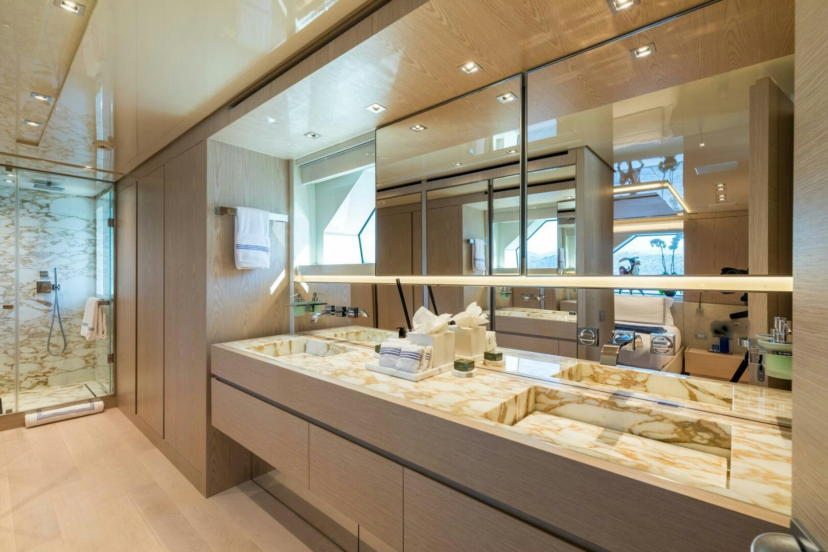 a large bathroom with a large mirror aboard GLORY Yacht for Sale