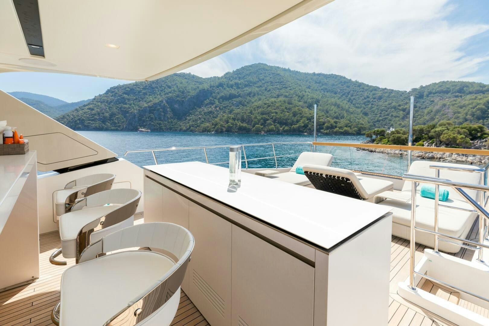 a room with a view of a mountain and water aboard GLORY Yacht for Sale