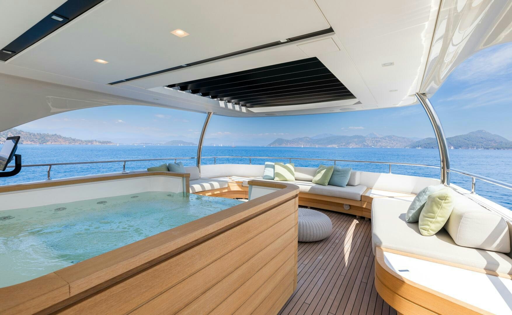 a boat with a deck and a view of the ocean aboard GLORY Yacht for Sale