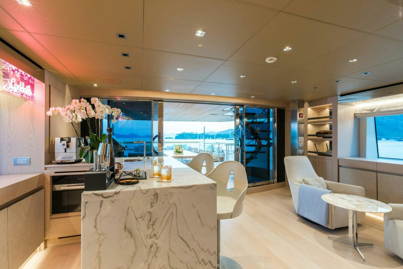 a room with a table chairs and a large window aboard GLORY Yacht for Sale