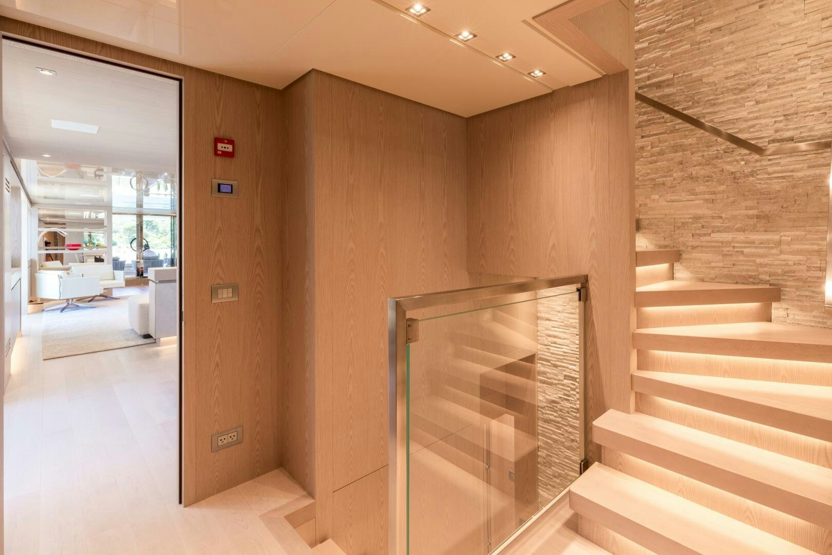 a large room with a staircase and a glass door aboard GLORY Yacht for Sale